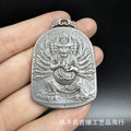 Close-up of a geometric iron pendant ornament in a Chinese style depicting the Aryaacalanatha Yamantaka motif.