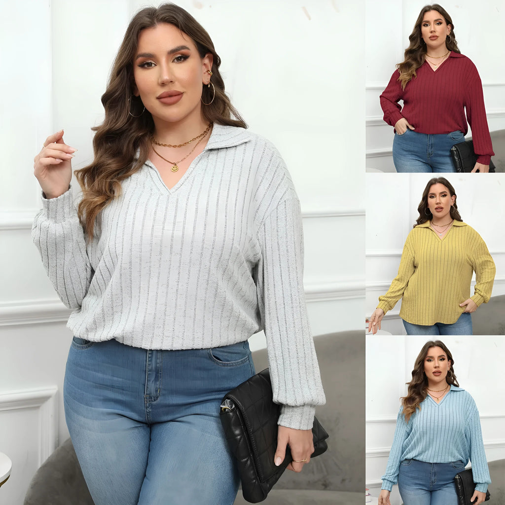 Plus size woman wearing a grey polo collar fleece pullover blouse with lantern sleeves.
