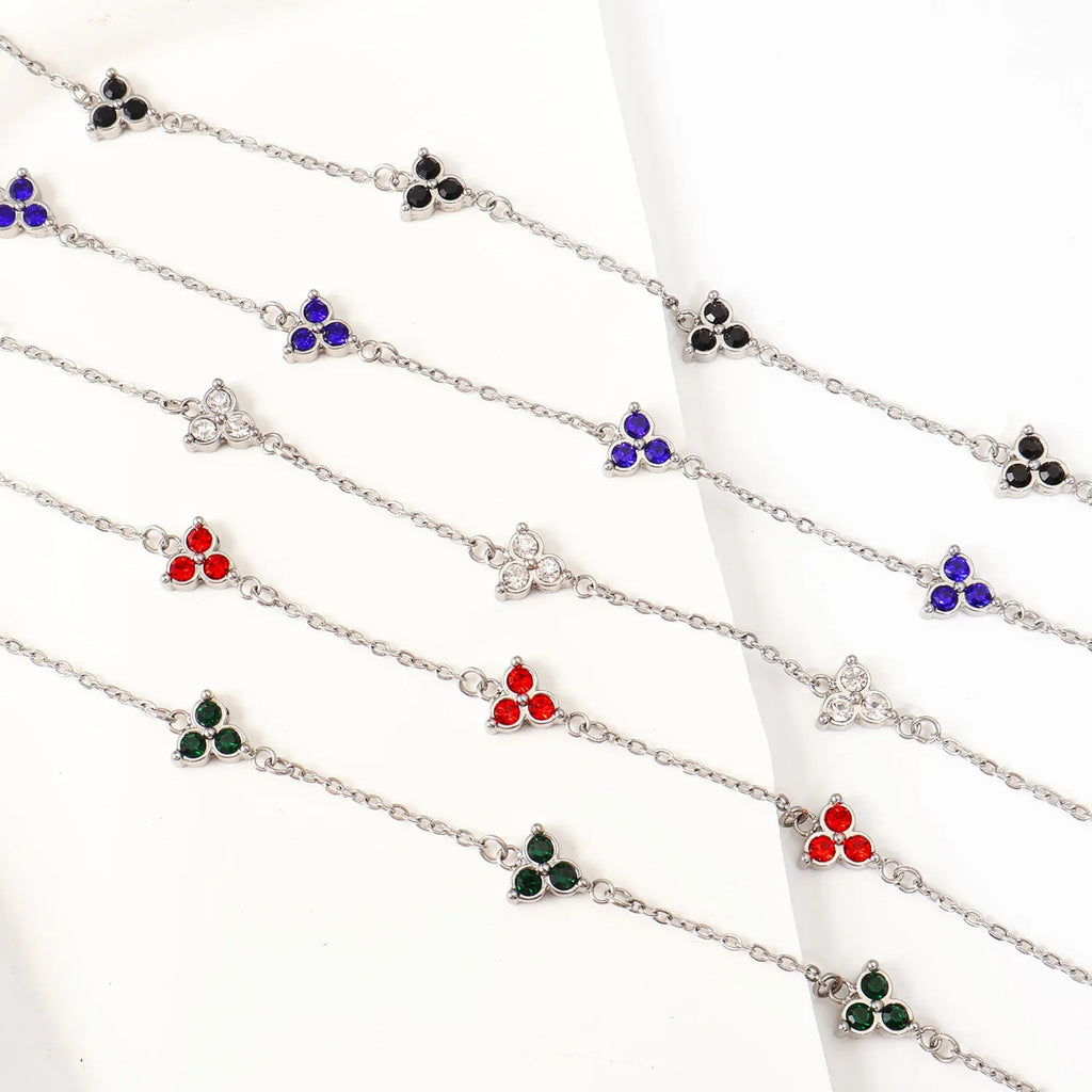 Women's stainless steel bracelet with a geometric triangle pendant, shown in gold and steel tone options with coloured stones.