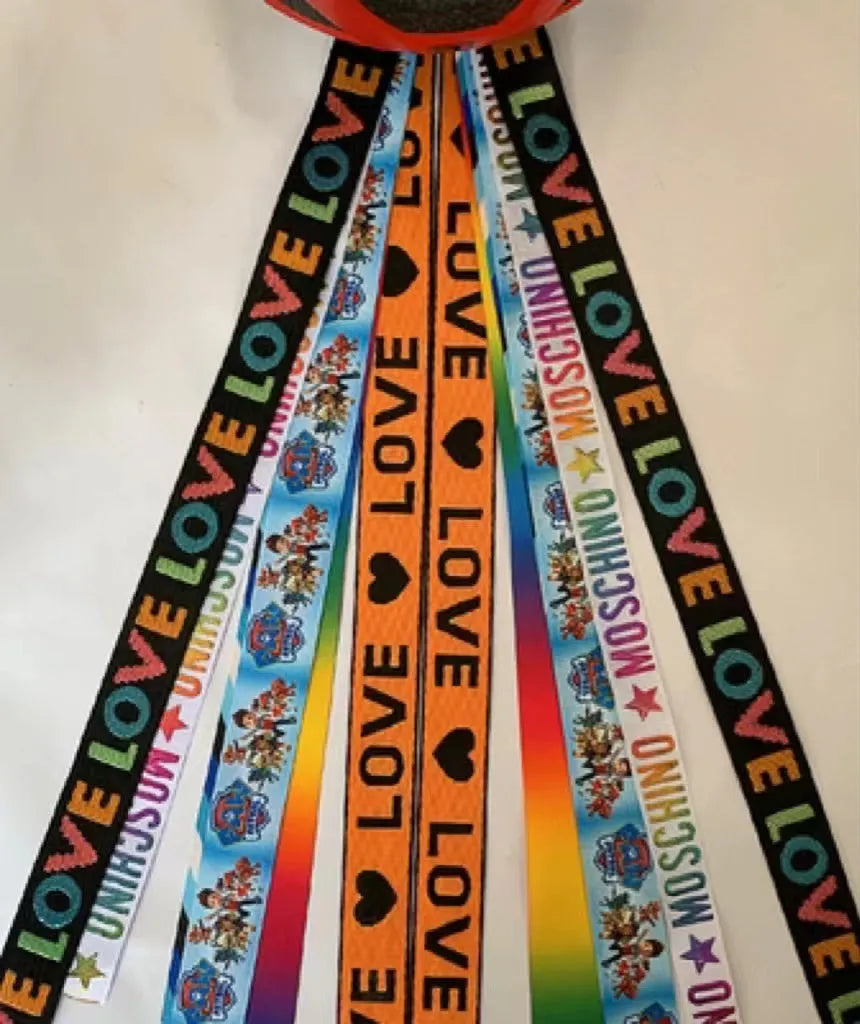 Close-up of a colourful decorative ribbon streamer attached to a child's helmet for roller skating or skiing.