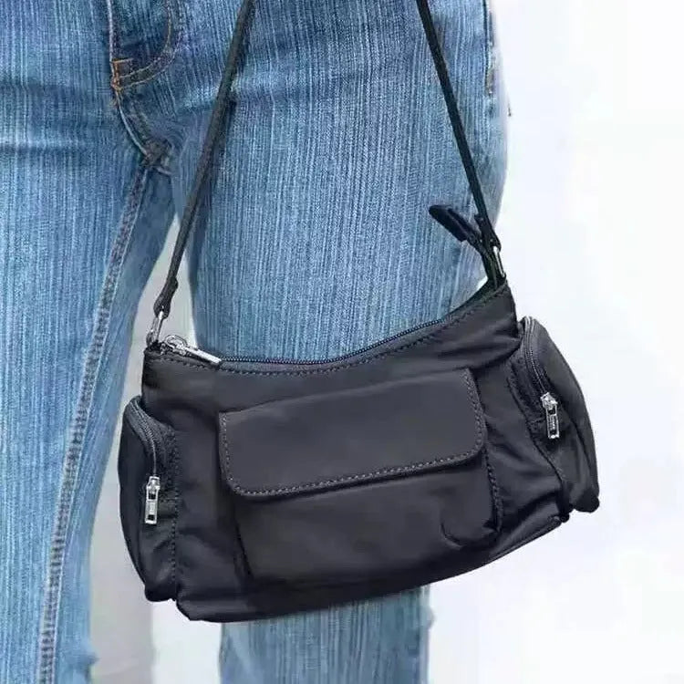 Black PU women's shoulder bag with two pockets, side-line detail, and a nylon lining.