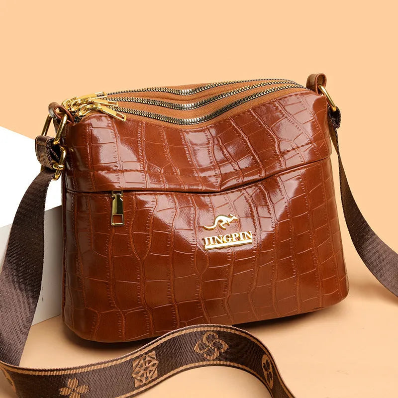 Large capacity multi compartment cross body bag in black with horizontal square shape and sewing thread detail