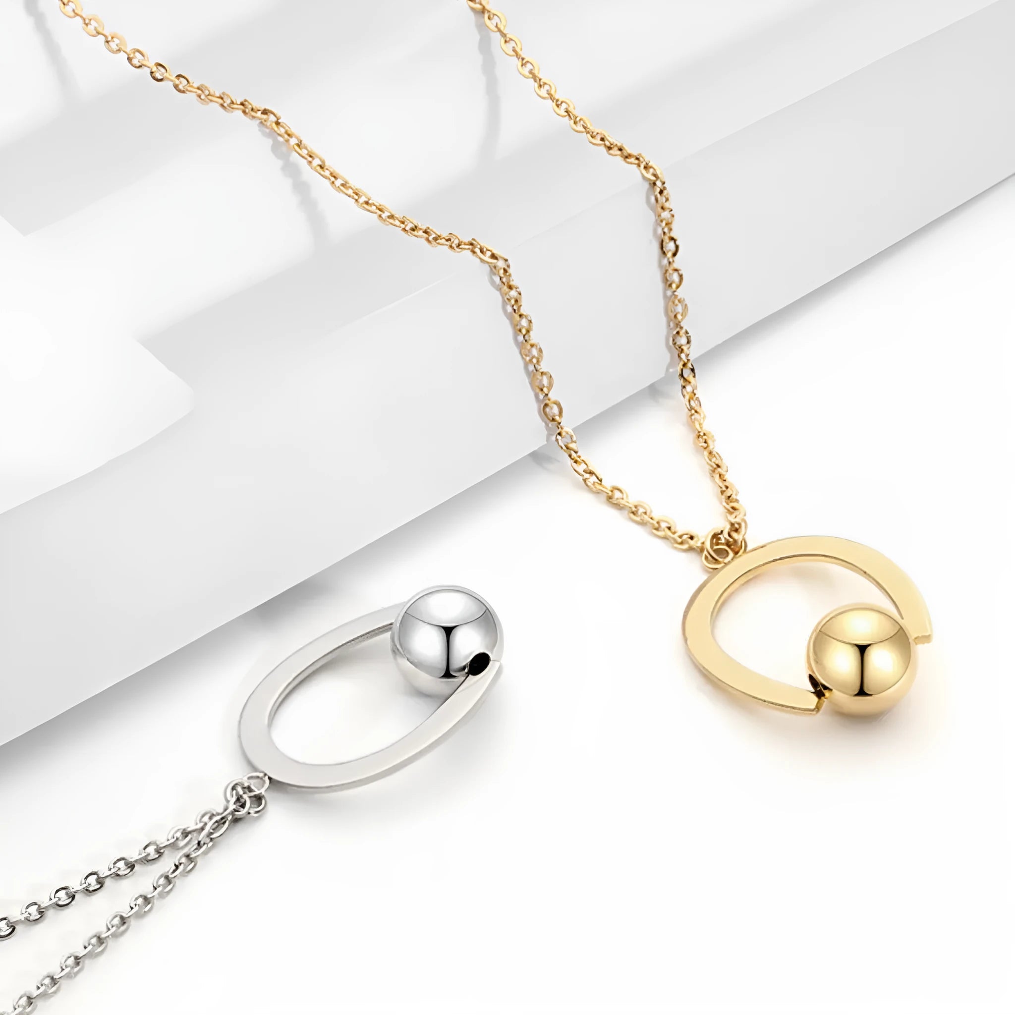 Stainless steel geometric pendant necklace on cross chain in gold or silver finish