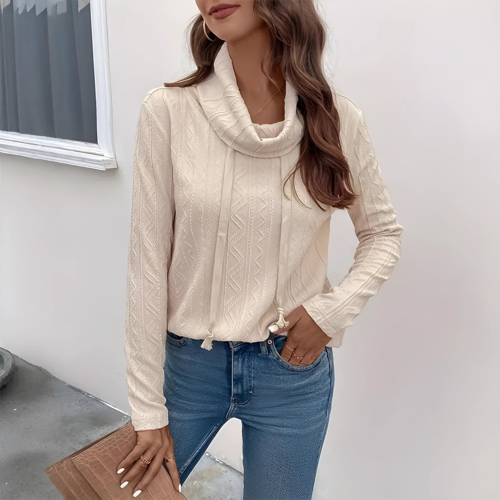 Apricot coloured pullover sweater with a drawstring hood and long sleeves laid flat.