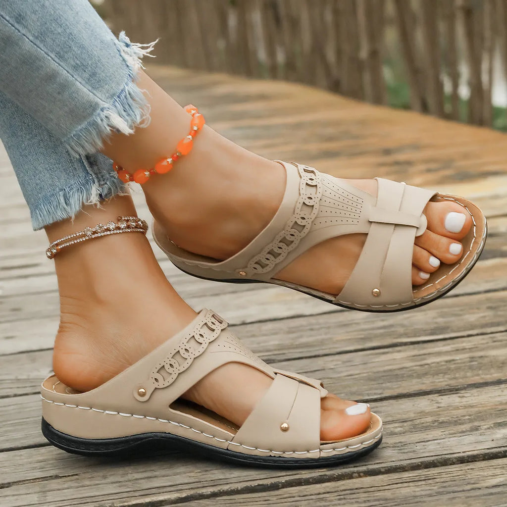 A pair of slope heel Roman style slippers with a fish mouth toe holder, shown in one of six available colours.