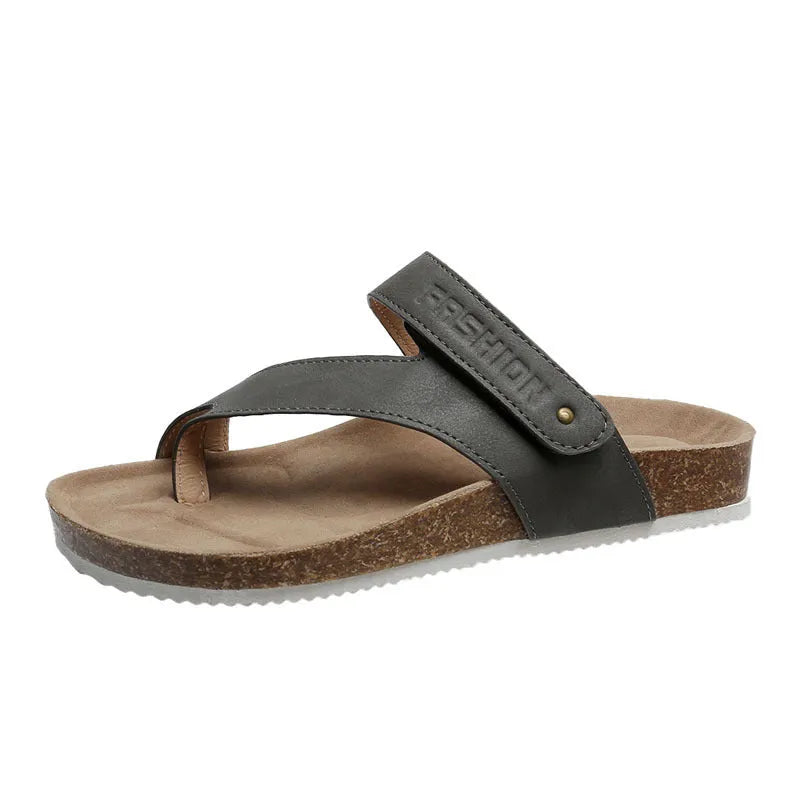 A pair of flat toe ring thick-soled flip-flops in a solid colour on a plain background.