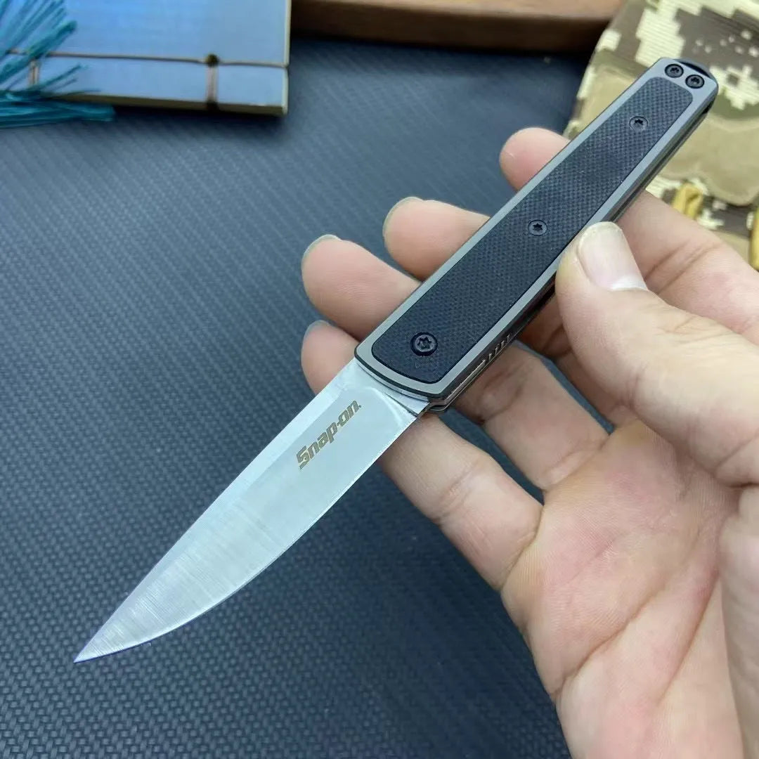 Folding fruit knife with stainless steel blade shown in black, brown, and red colour options