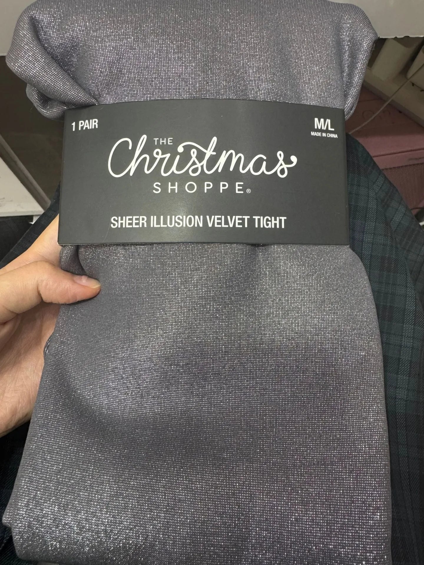 Women's black thermal leggings with a wool lining, shown in a flat lay.