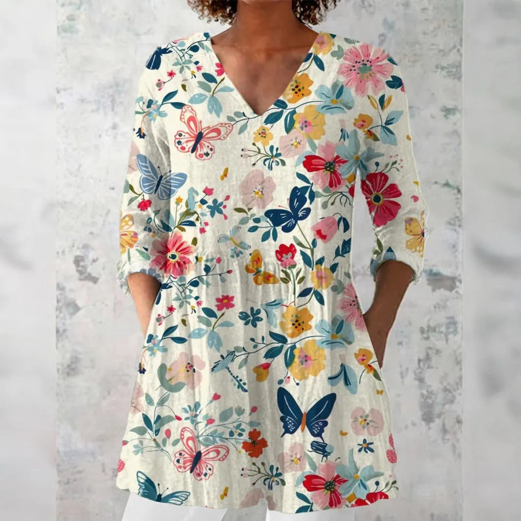 Woman wearing a retro slim fit, digitally printed long-sleeved top in a floral design.