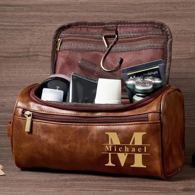 Men's neutral-coloured PU travel organiser with multiple compartments open showing interior layout
