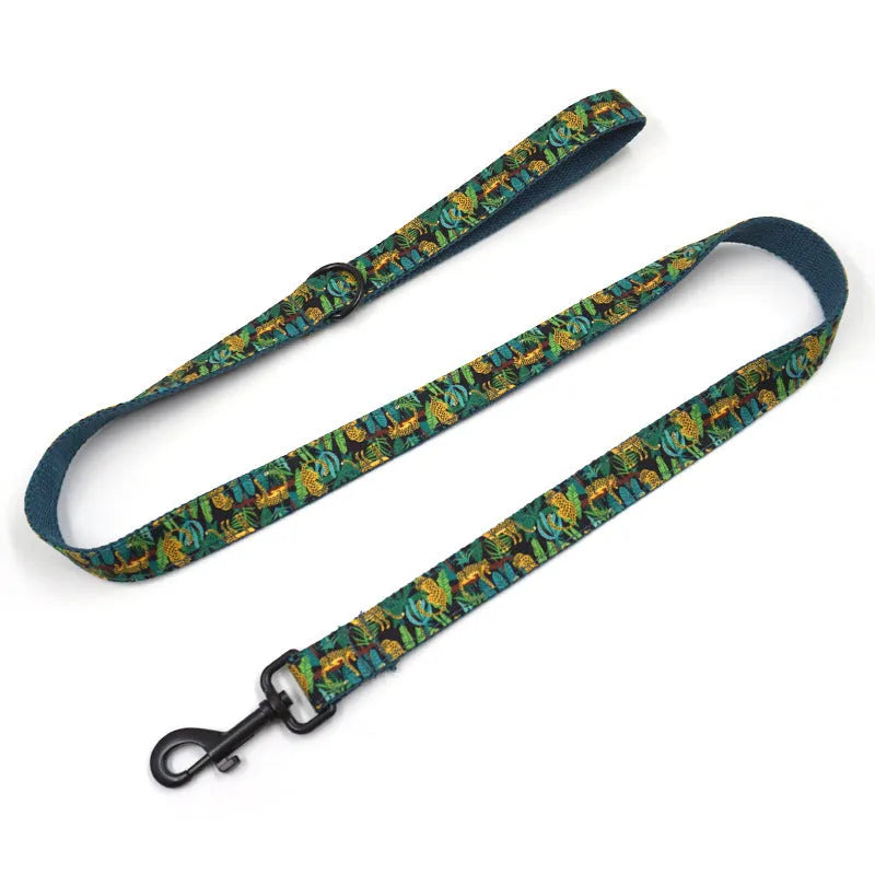 Green cloth pet collar and leash set with bowknot print on a white background showing collar and leash together