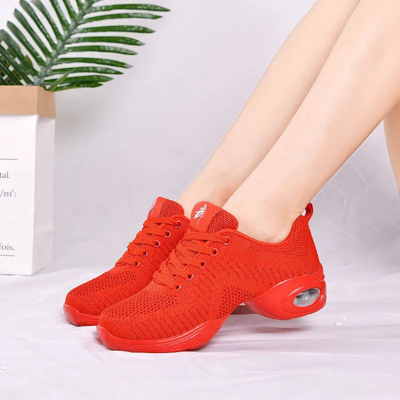 Women's white breathable flyknit mesh dancing shoes with a soft PU sole on a light background.