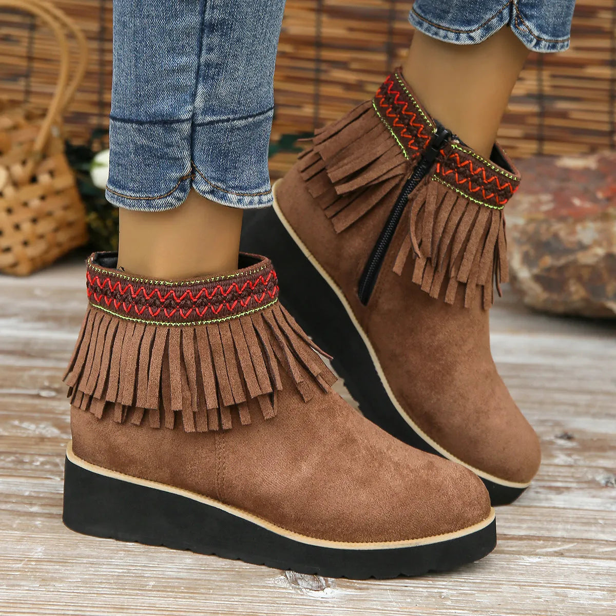 Women's dark brown suede wedge ankle boot with side zip, tassel, and thick rubber sole.