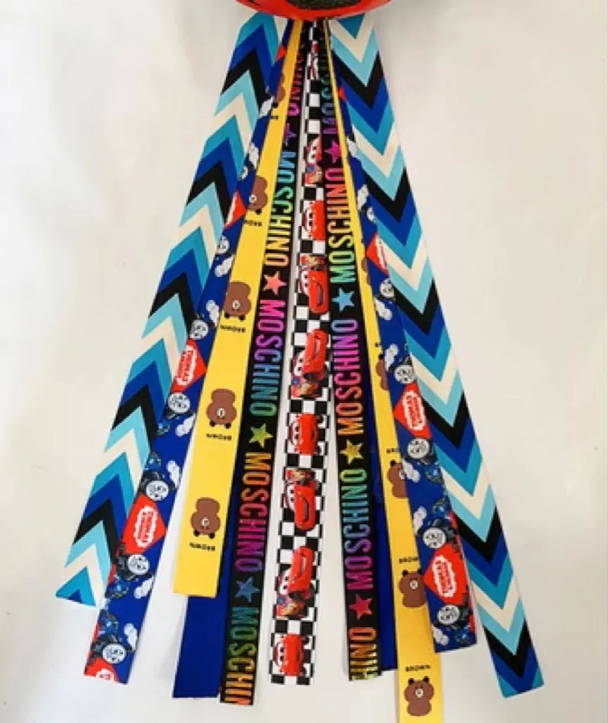 Close-up of a colourful decorative ribbon streamer attached to a child's helmet for roller skating or skiing.
