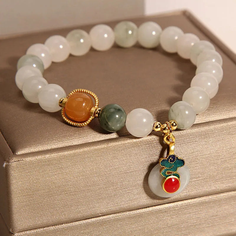 Women's ice jade bracelet with pearl accents and carved Xiangyun peace jade buckle