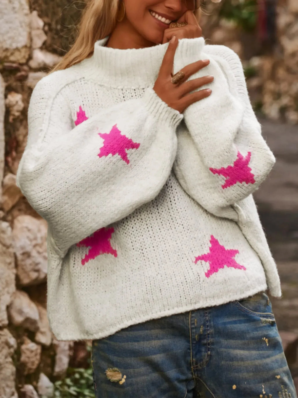 White women's loose fit turtleneck pullover with five-pointed star pattern detail