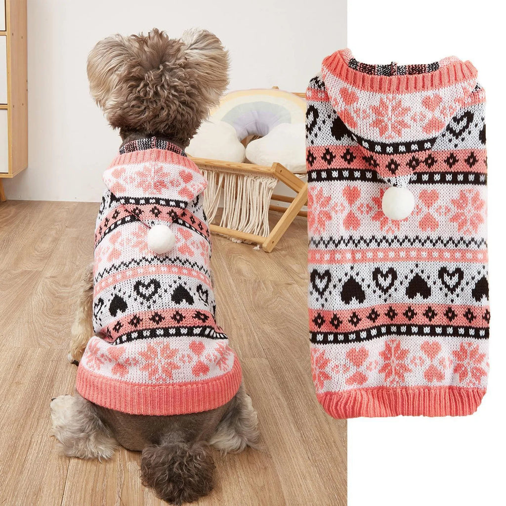 Pink knitted dog jumper with snowflake, love heart, and striped camouflage pattern on a small white dog.