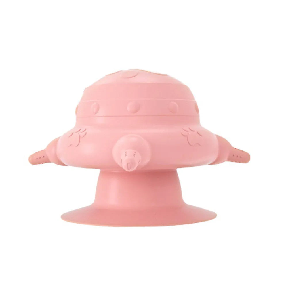 Pink silicone pet milk feeder with four nursing pacifiers and a lid on a flat base.