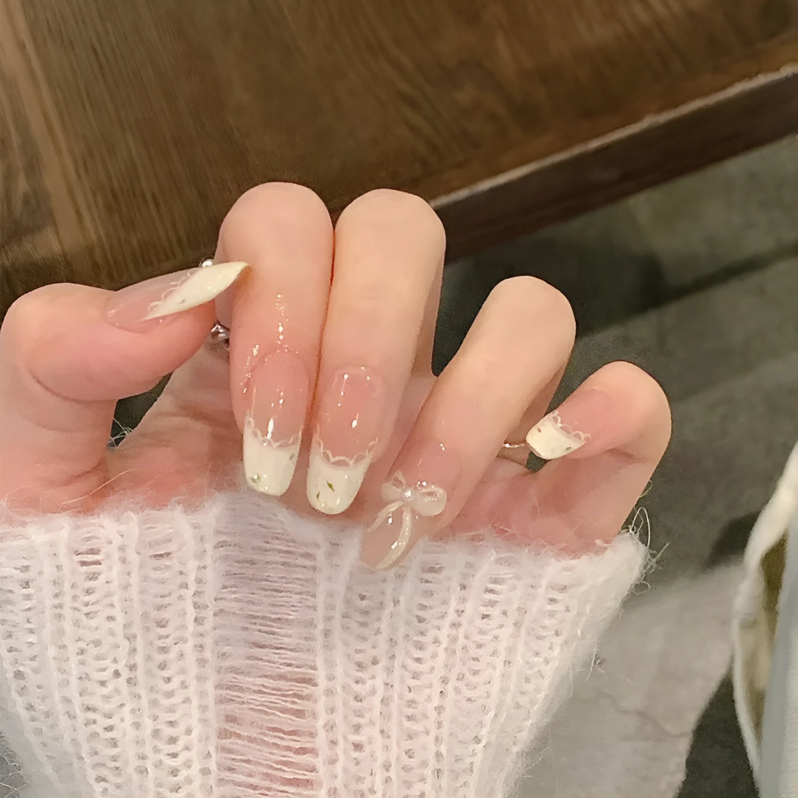 False nails with hand-glued crystal decorations in random mixed colours creating 3D nail art designs