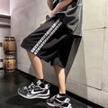 Men's loose-fitting track pants in grey with elastic waistband and baggy leg design