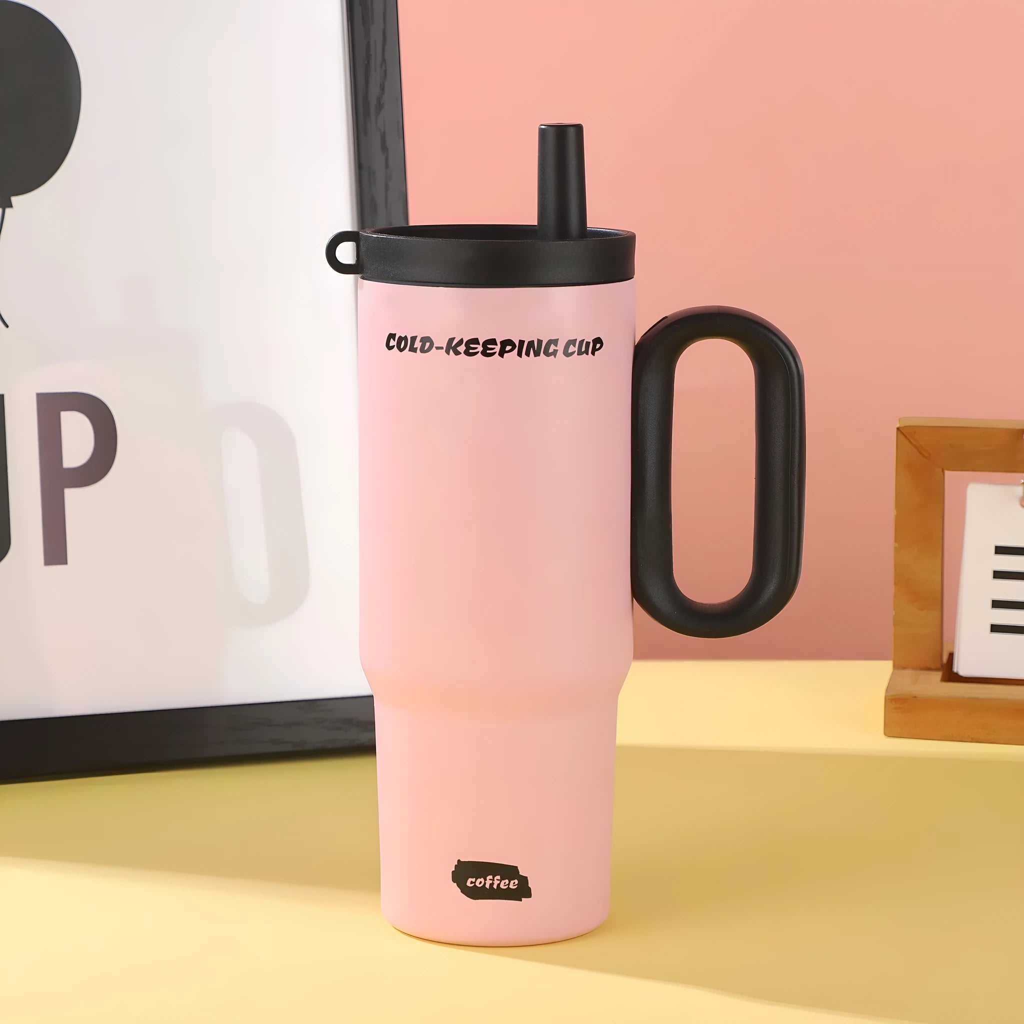 Large insulated straw drinking cup with a carrying handle in various colours.
