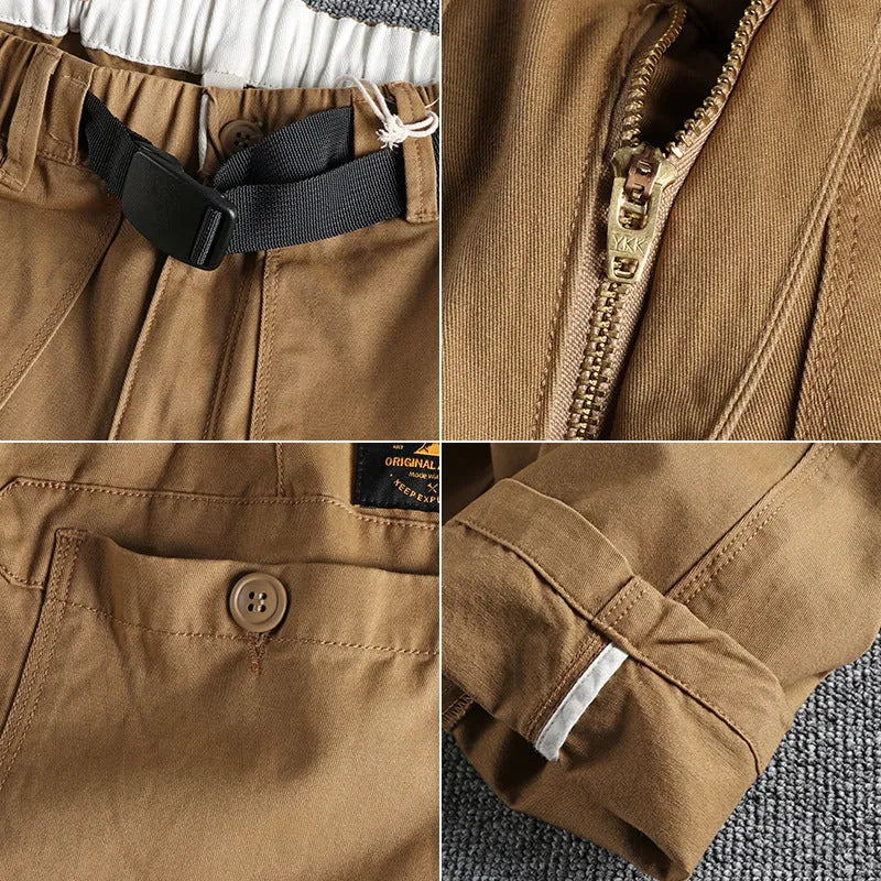 Men's khaki cotton work trousers with three-dimensional cutting and a silver N I buckle belt on the waist.