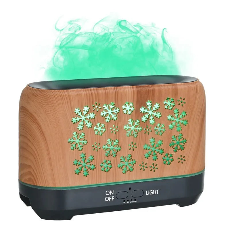 Colourful snowflake pattern aromatherapy humidifier with glowing flame effect and remote control on a desktop.