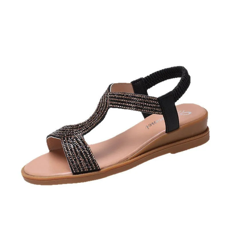 Women's patent leather sandals with rhinestone decoration on round toe shape, shown in gold colour