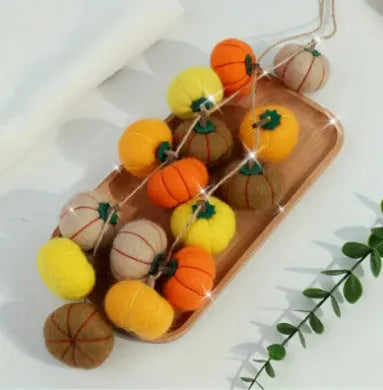 Wool felt pumpkin ornament in assorted colours for dollhouse decoration, approx. 5cm wide.