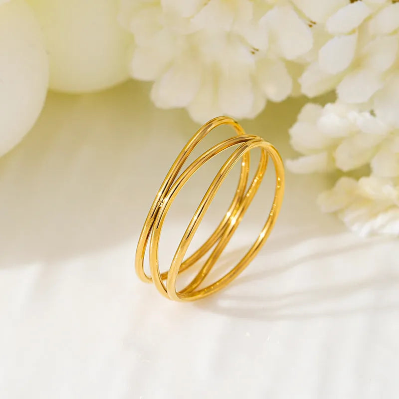 Gold geometric titanium steel ring with three-layer coil design on size chart showing options 5 to 10.