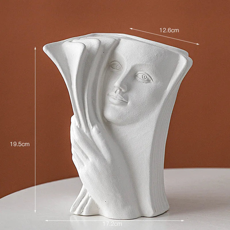 Ceramic book stand with glazed finish in one of four artistic designs on a desk.