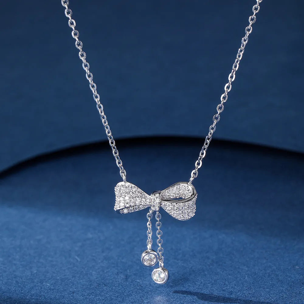 S925 sterling silver necklace with a bow pendant on an adjustable O-ring chain.
