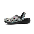 Black women's platform sandals with rhinestones around holes and a textured EVA sole.