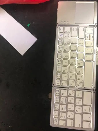 Black tri-fold folding Bluetooth keyboard with touchpad, shown both folded and unfolded.