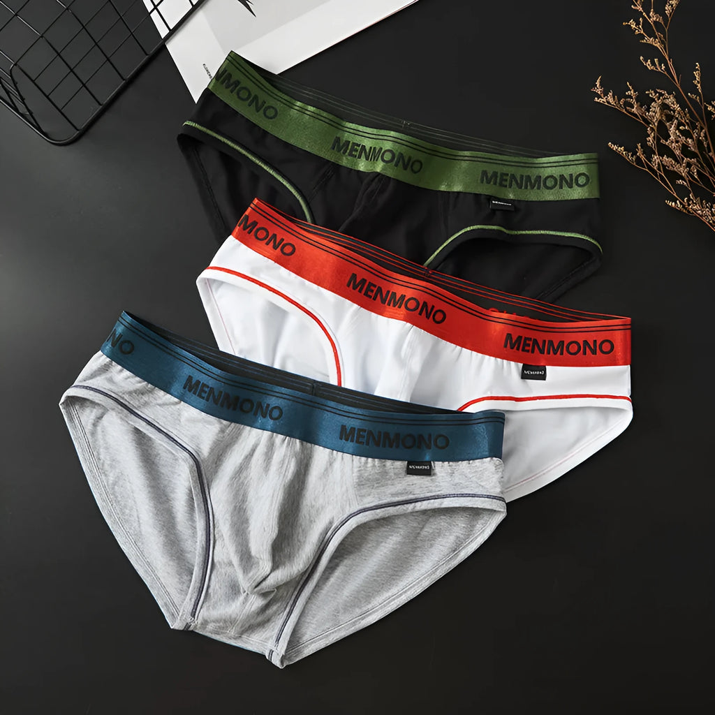 Men's low waist cotton briefs in a selection of solid colours including black and blue, white and red.