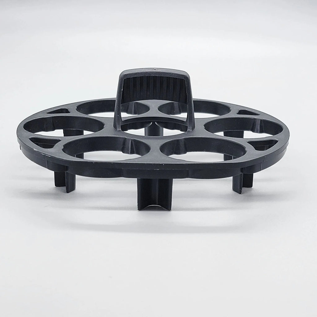 Black plastic egg holder basket rack for a cooking machine on a white background.