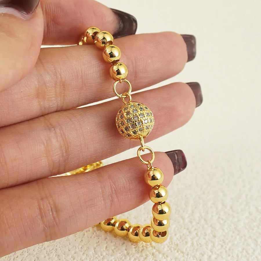 Copper bracelet with heart shape design, zircon accents and Arabic style patterning