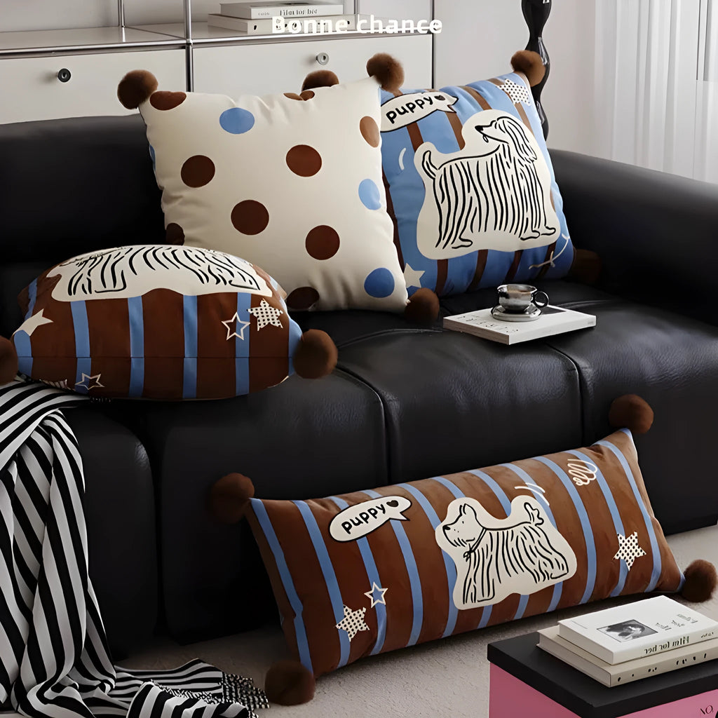 Blue cartoon animal printed cushion on a grey sofa showing removable cover.