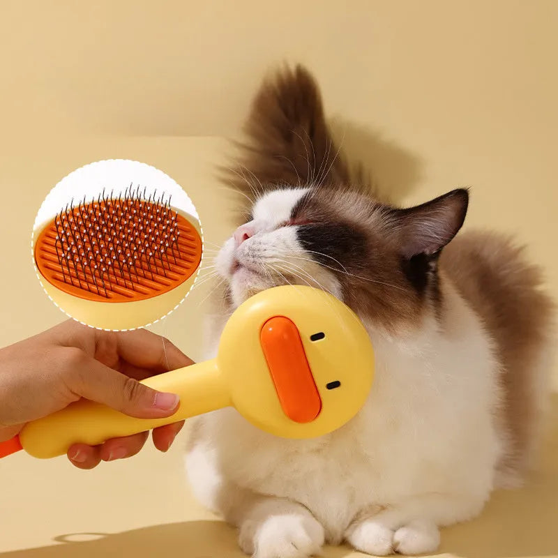 Small yellow duck-shaped pet comb with open sections and floating needles for cat and dog hair removal