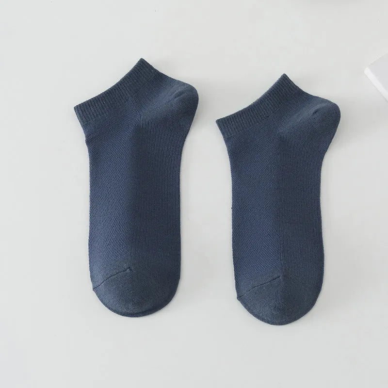 A pair of solid colour low-cut boat socks made from breathable polyester, shown in one of six available colour options.