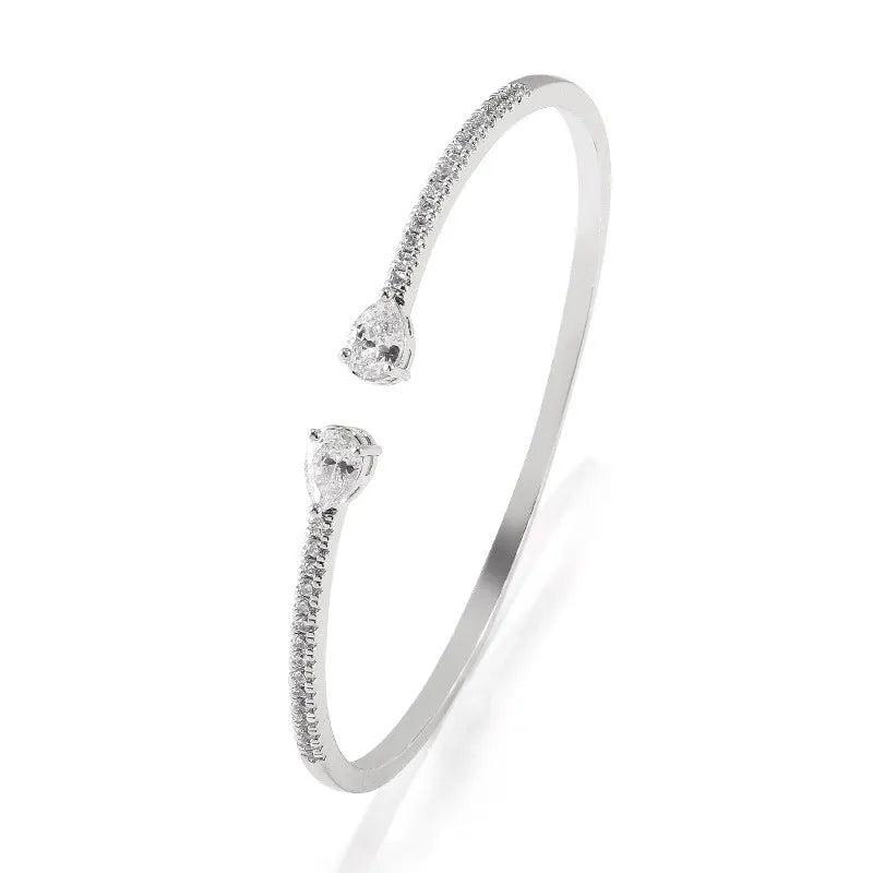 Personalised multi-zircon bracelet in copper, showing detailed inlaid stonework in a simple band style.