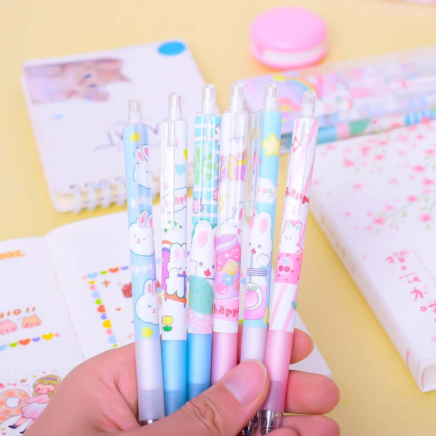 Six black plastic pens with cartoon bunny design and 0.5mm fine tips in an open box.