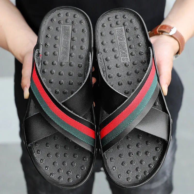 Men's white cowhide leather flip-flop sandals with a non-slip PU sole on a beach background.