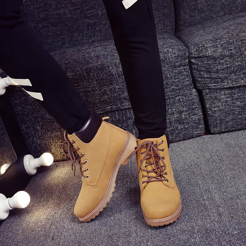 Men's pink high-top Martin boots with front lace-up and a low flat heel on a neutral background.