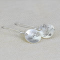 Silver women's earrings with bird and flower motifs on glossy round zinc alloy design
