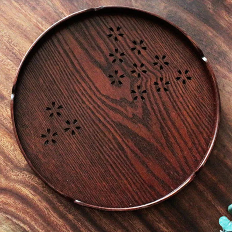 Wooden shallow plate with etched cherry blossom design, approximately 30 cm in diameter.