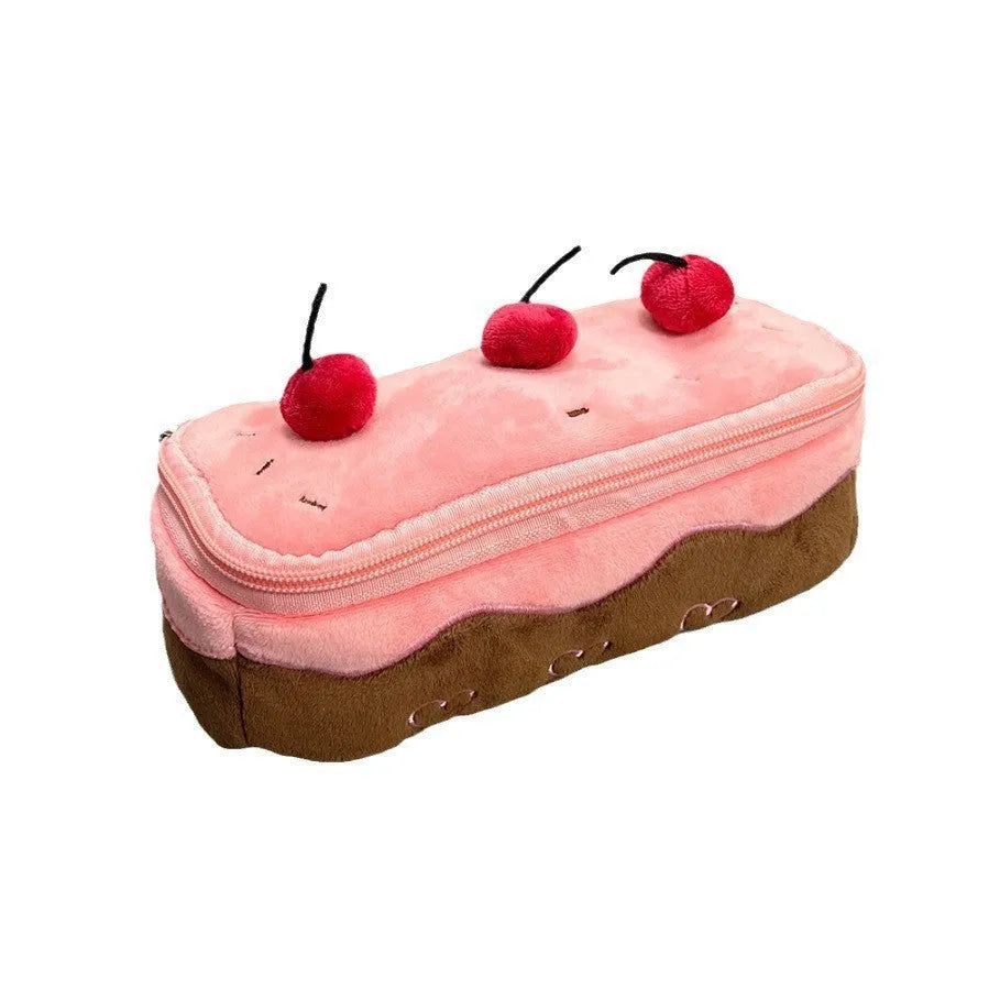 Red velvet pencil bag with cherry cake pattern print, open to show empty interior.