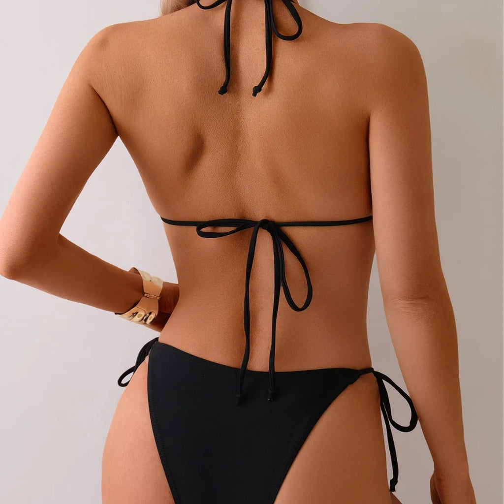 Black women's bikini swimsuit with metal bead detailing and split leg design