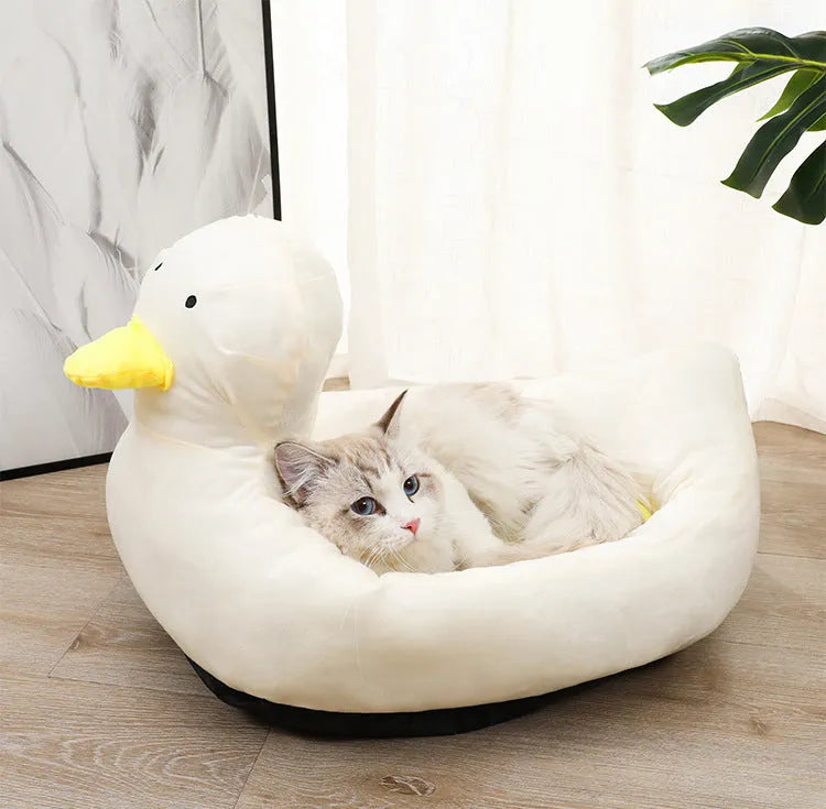 Blue duck-shaped fluffy pet sofa bed for small dogs and cats on a white background.