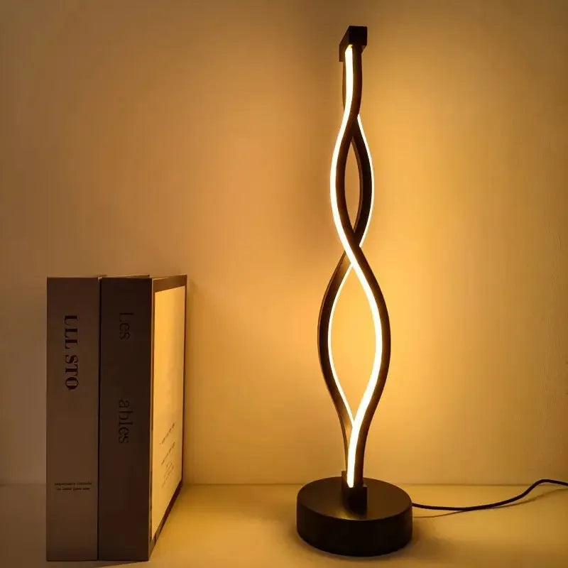 Black aluminium desk lamp with a touch dimming button for blue, pink, and warm white light.